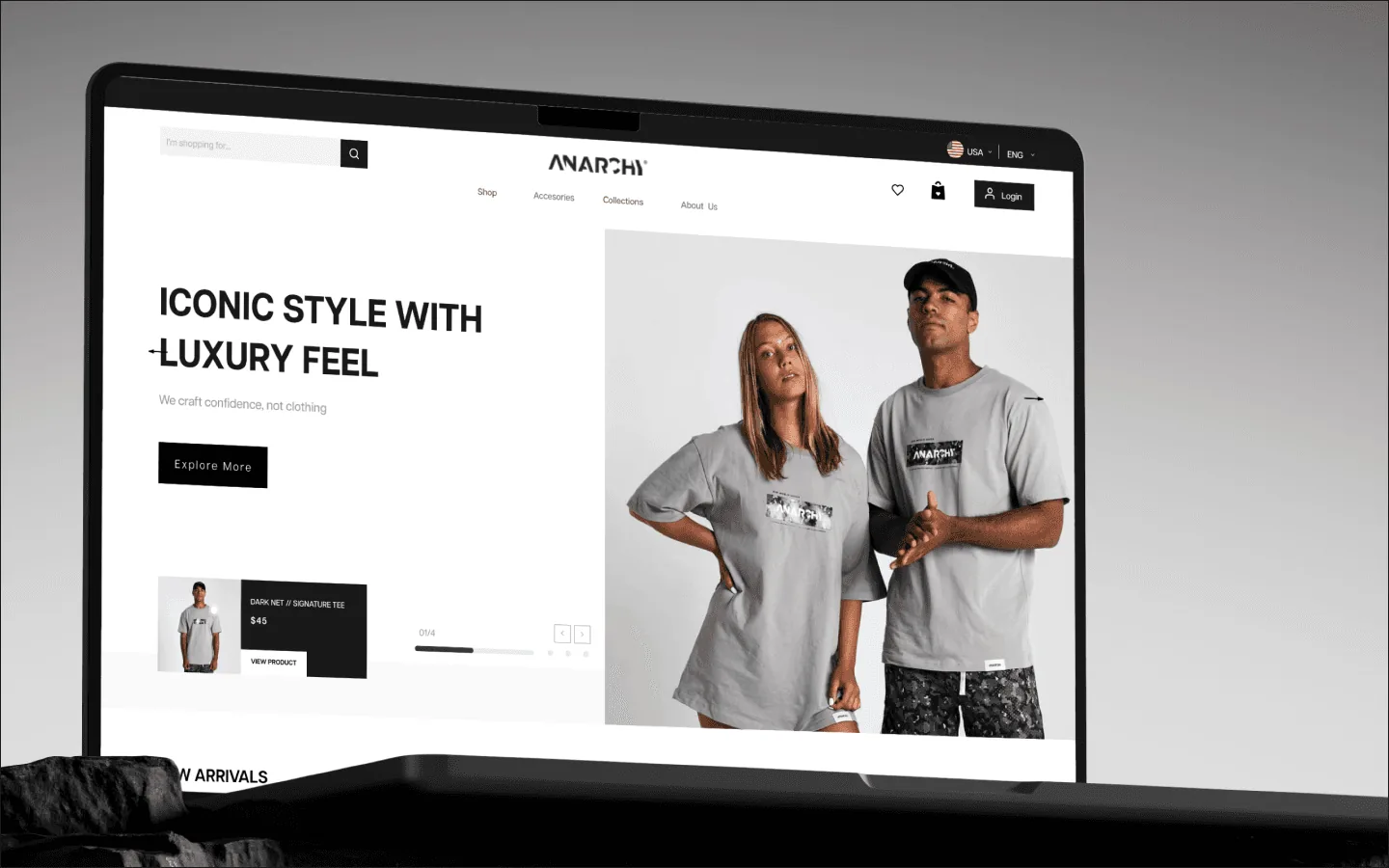 A laptop showing the Anarchy home page: a navigation bar, the headline Iconic style with luxury feel, and a photograph of two models in grey tees and shorts.