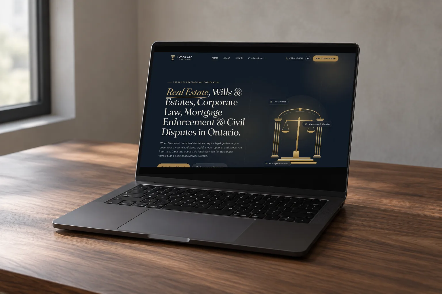 A laptop on a wooden desk by a window, open on the live Tokas Lex Law Office home page: a dark navy hero listing its practice areas in Ontario.